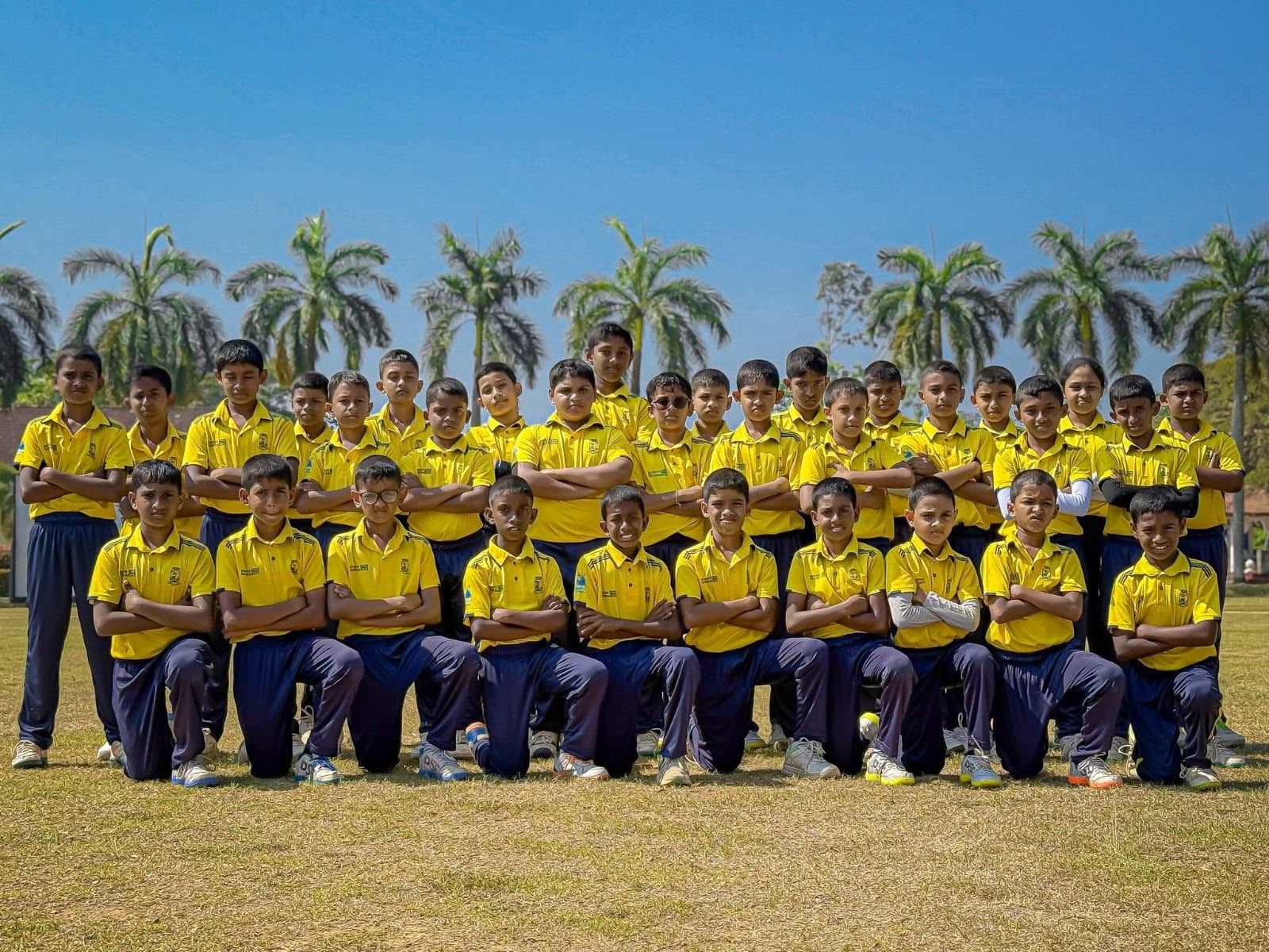 The Crickpitch academy squad in their yellow and navy kit